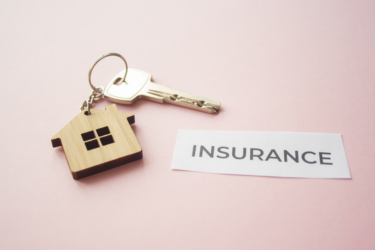 Wooden house toy and silver key on bright pink background with phrase quote Insurance. Mortgage, house buy sell, investment, rent, Real Estate Agent concept