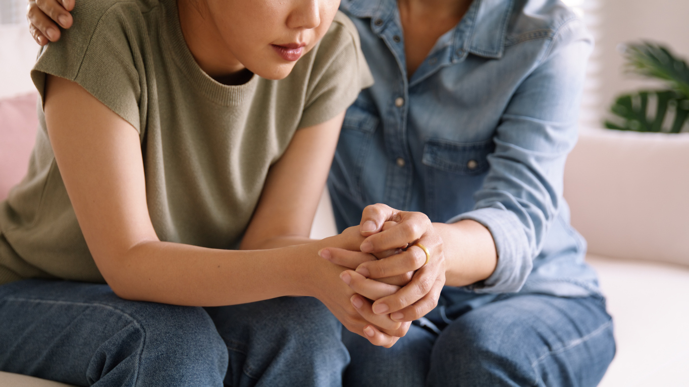 a child suffering from anxiety speaking with her mother