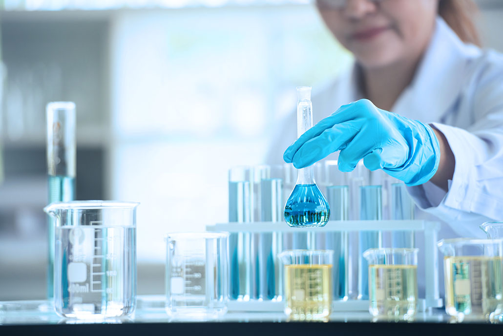 Scientist working with liquids in glassware